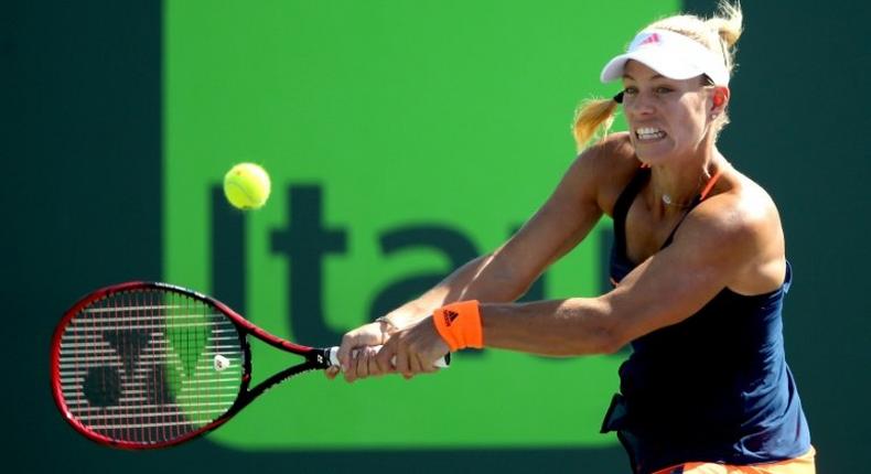 Angelique Kerber of Germany returns a shot to Risa Ozaki of Japan during their Miami Open 4th round match, at the Crandon Park Tennis Center in Key Biscayne, Florida, on March 27, 2017