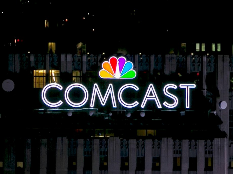 The NBC and Comcast logo are displayed on top of 30 Rockefeller Plaza, formerly known as the GE building, in midtown Manhattan in New York