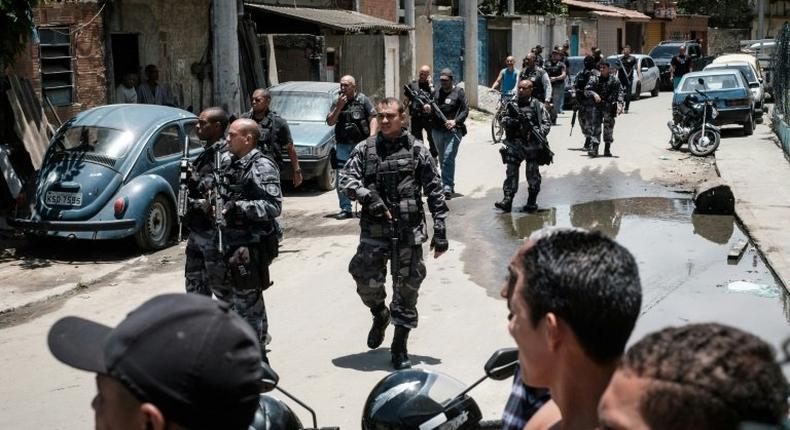 Brazilian police officers patrol in the City of God favela in Rio de Janeiro, Brazil, on November 20, 2016