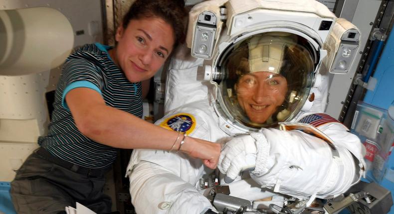 FILE - In this image released Friday, Oct. 4, 2019, by NASA, astronauts Christina Koch, right, and, Jessica Meir pose for a photo on the International Space Station. NASA has moved up the first all-female spacewalk to Thursday, Oct. 17, 2019, or Friday because of a power system failure at the International Space Station.  (NASA via AP)