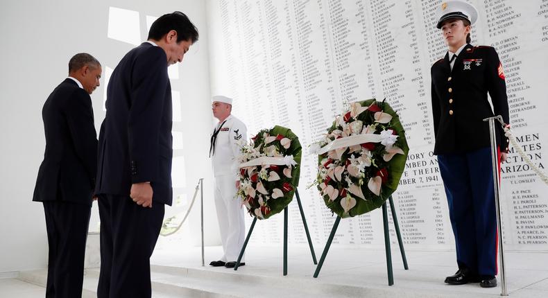 Shinzo Abe and Barack Obama participate in a wreath-laying ceremony aboard the USS Arizona Memorial at Pearl Harbor, Hawaii, U.S., December 27, 2016.