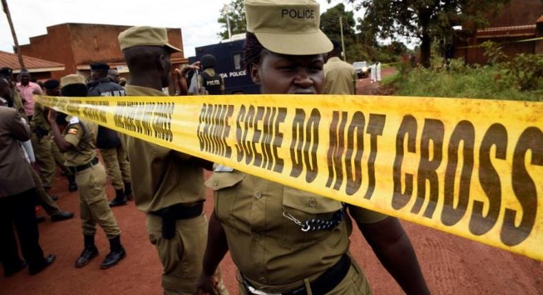 Uganda's police officers cordon off the scene where senior police officer Andrew Felix Kaweesi was murdered in a Kampala Suburb on March 17, 2017