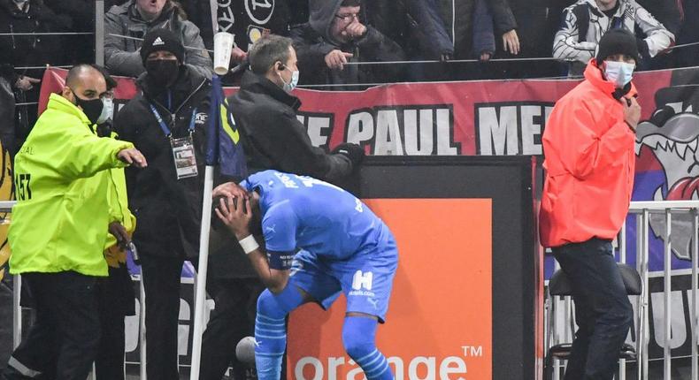 Marseille's Dimitri Payet was struck on the head by a bottle of water thrown from the crowd as he went to take a corner in the Ligue 1 game against Lyon last month Creator: PHILIPPE DESMAZES