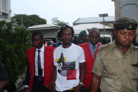 Naira Marley being led to court by men of the EFCC amidst a watertight security. [Twitter/@officialEFCC]