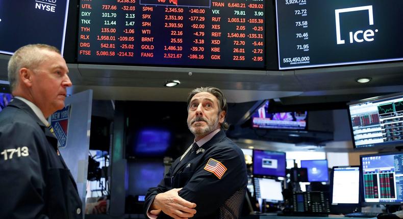 Traders look on after trading was halted on the floor of the New York Stock Exchange (NYSE) in New York, U.S., March 18, 2020Lucas Jackson/Reuters