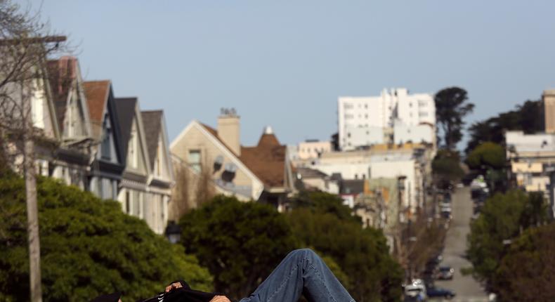 A man sleeps in San Francisco's Duboce Park.