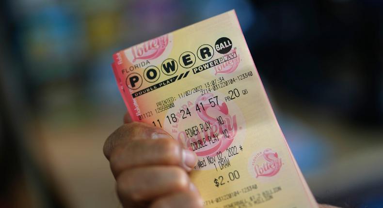 A man displays his Powerball lottery numbers after buying a ticket at a convenience store in Miami, November 2, 2022.Rebecca Blackwell/AP Photo