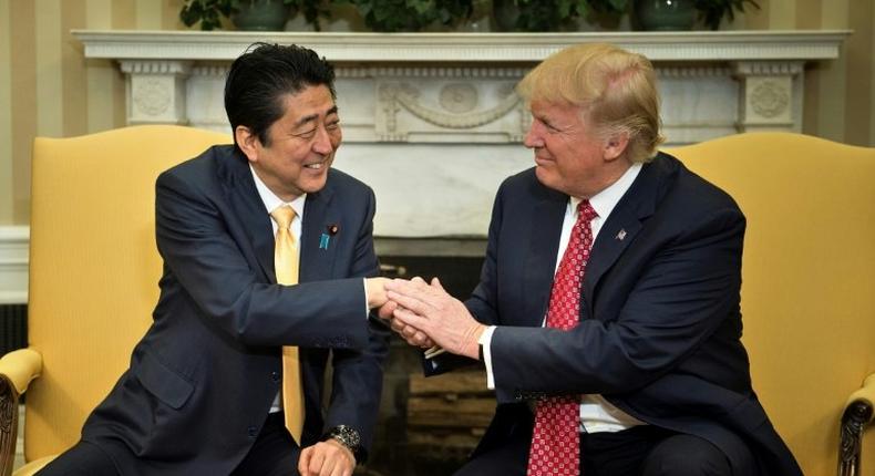 US President Donald Trump praised Japanese Prime Minister Shinzo Abe's strong hands after greeting him with a hug at the White House