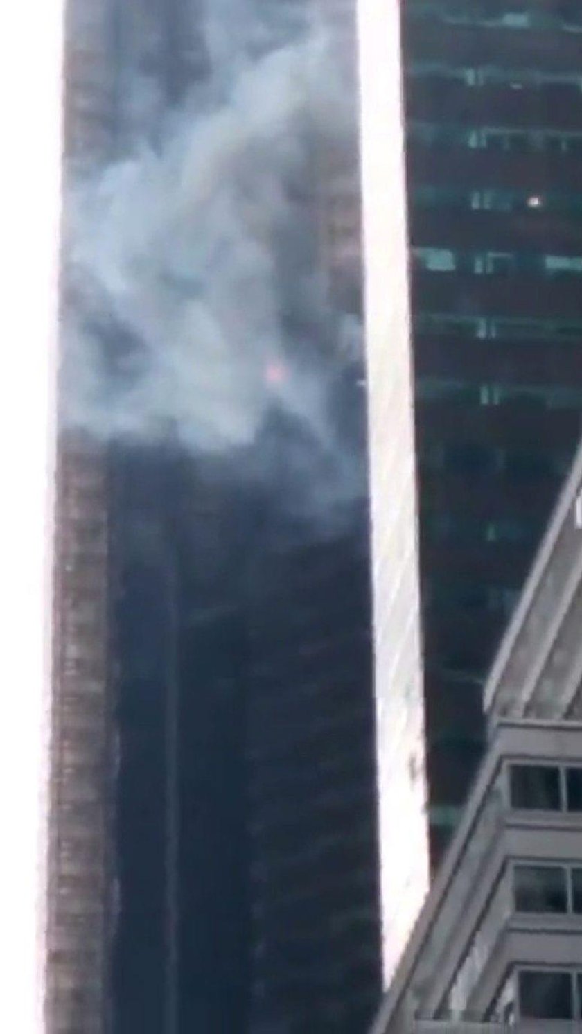 Damaged windows are seen after a fire in a residential unit at Trump Tower in New York