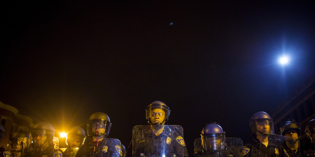 Police line up shortly after the deadline for a city-wide curfew at North Ave and Pennsylvania Ave in Baltimore, Maryland April 30, 2015.