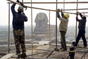 Labourers work on scaffolding near a full-scale replica of the Sphinx at an unfinished movie and animation tourism theme park, in Chuzhou