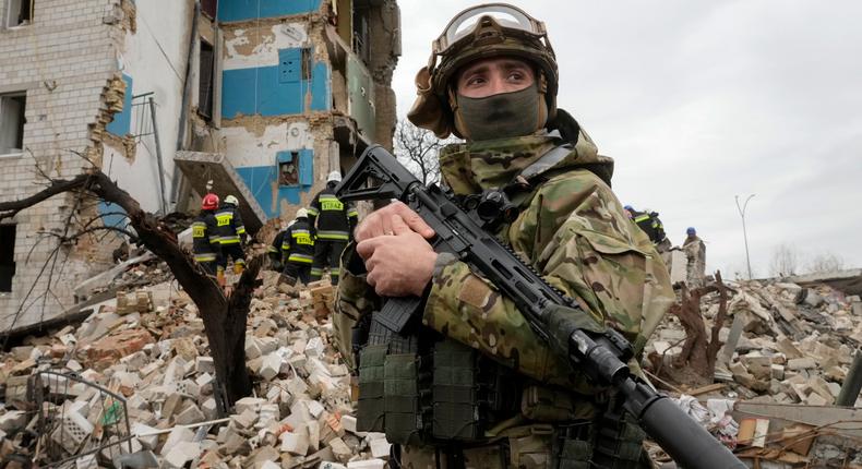 A Ukrainian soldier stands near an apartment ruined from Russian shelling in Borodyanka, Ukraine, Wednesday, Apr. 6, 2022.