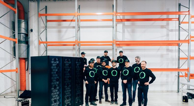 The Cactos team stand alongside battery storage units.Cactos/Mikko-Pekka Karlin