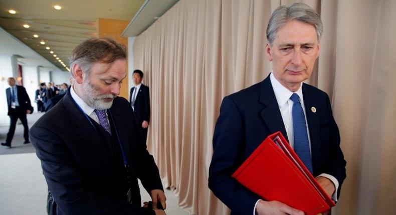 Former UK ambassador to Russia Tim Barrow (L) and Britain's Foreign Minister Philip Hammon arrive for the fourth session of the G7 Foreign Ministers' meeting in Hiroshima on April 11, 2016