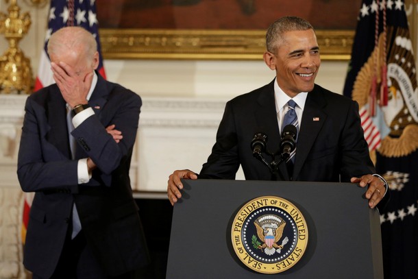 Vice President Joe Biden (L) reacts as President Barack Obama delivers remarks