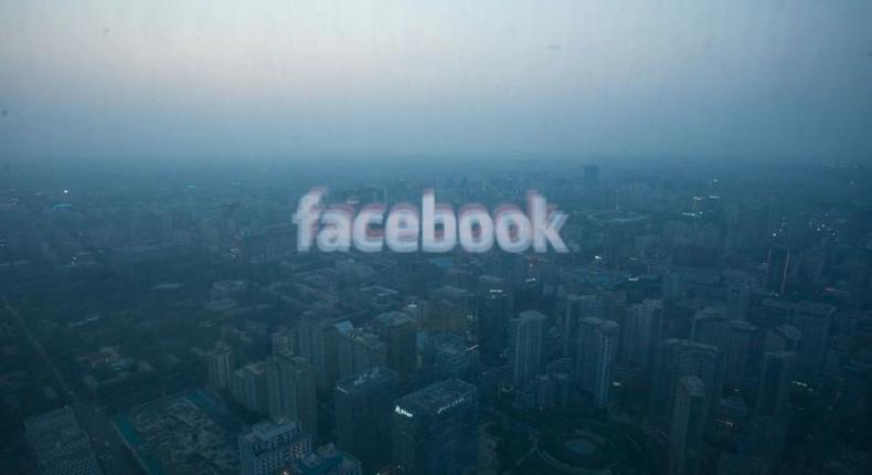 A computer screen displays the logo of social networking site Facebook against the backdrop of the Beijing skyline