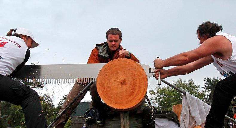 Amanda Beams (L) and her husband Dale Beams, from Winkleigh, Australia compete in the Jack and Jill double buck event during the Lumberjack World Championships in Hayward, Wisconsin.