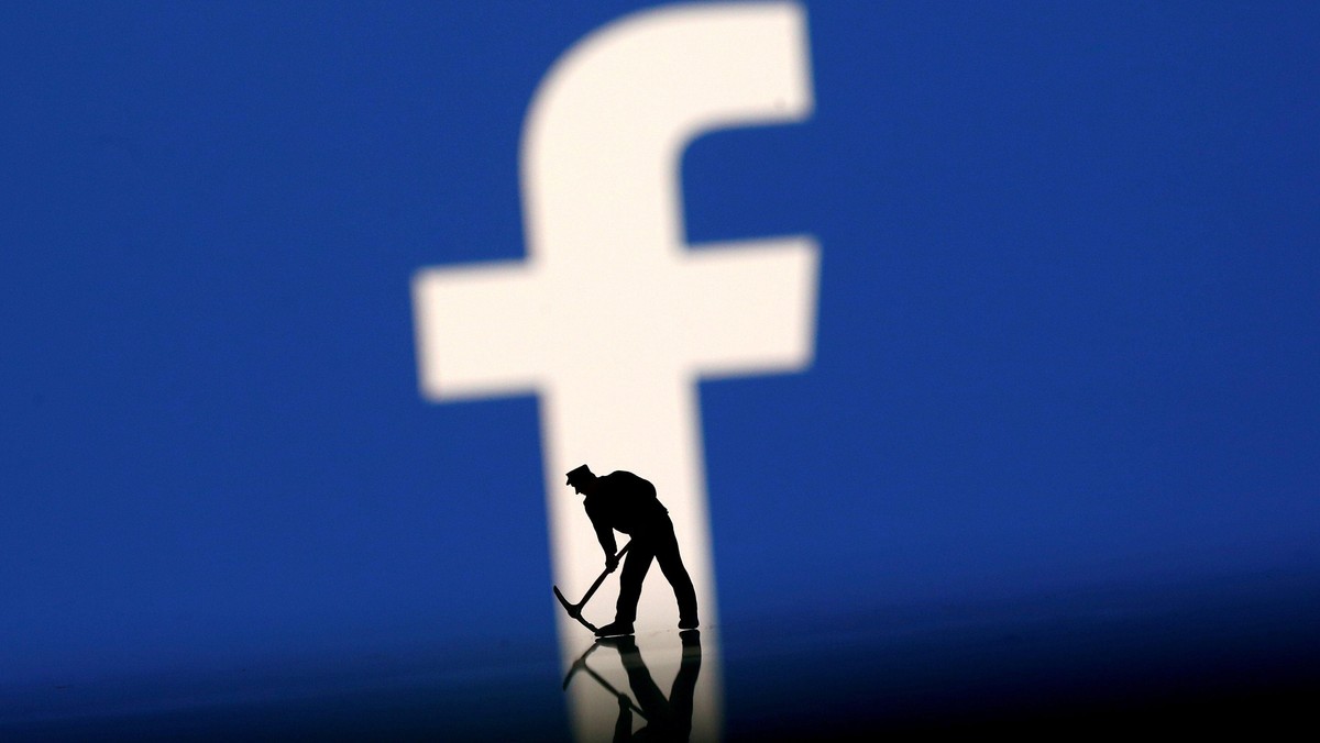 FILE PHOTO: A figurine is seen in front of the Facebook logo in this illustration