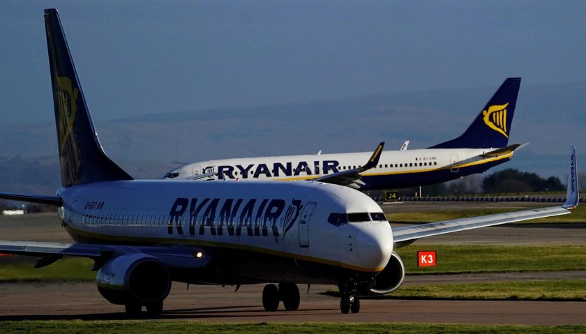 A cabin crew member serves passengers onboard a Ryanair passenger aircraft travelling from Madrid In