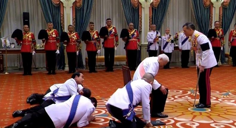 Thai officials present themselves to new Thai King Maha Vajiralongkorn (right) in December