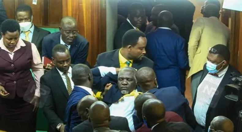 Legislators carrying Eddie Kwizera out of Parliament after he collapsed