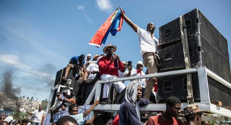 Demonstrators take part in a protest demanding the resignation of President Jovenel Moise in the Haitian capital in Port-au-Prince on October 20, 2019