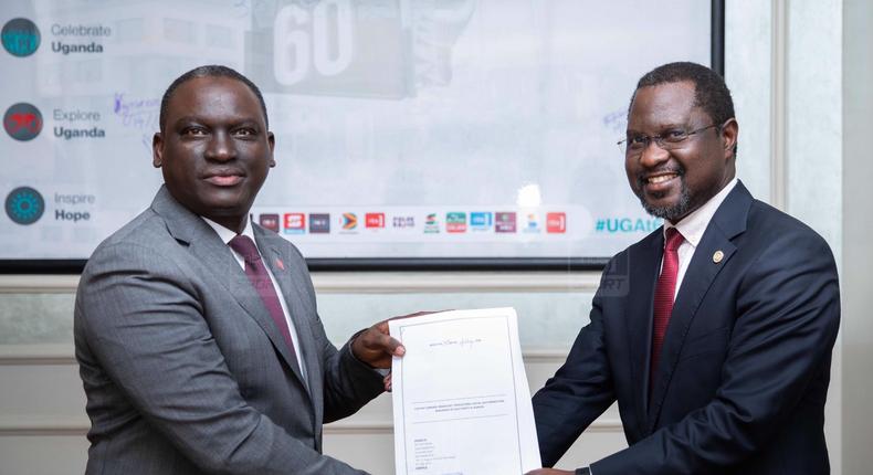 Next Media Group CEO Kin Kariisa(left) and Uganda Golf Union Presidenrt Dr. Jackson Were(right) after signing the MOU that makes NBS Sport the official Golf media partner