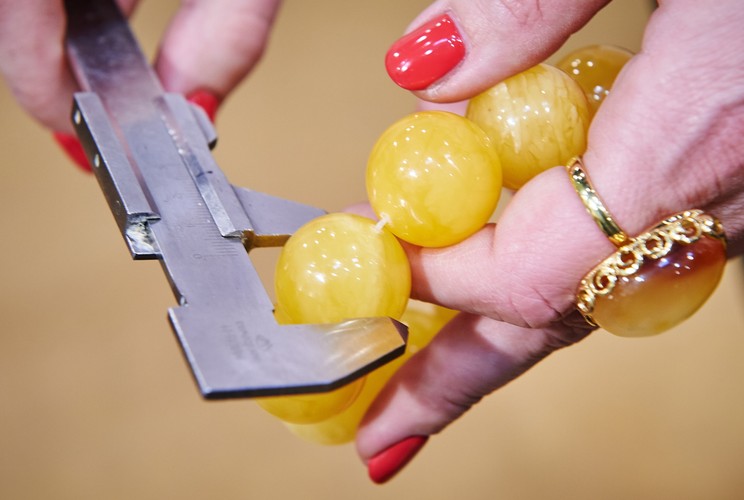 Mierzenie średnicy bursztynowych korali na stoisku firmy A2 Studio Biżuterii, na Międzynarodowych Targach Bursztynu, Biżuterii i Kamieni Jubilerskich AMBERIF 2015 w Gdańsku<br><br>fot. (aw/cat) PAP/Adam Warżawa