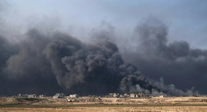 Smoke rises from burning oil wells in Qayyarah, on the outskirts of Mosul, on November 4, 2016