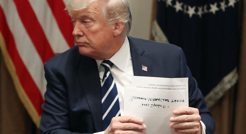 U.S. President Donald Trump holds his notes as he talks about his meeting with Russian President Vladimir Putin, during a meeting with House Republicans in the Cabinet Room of the White House on July 17, 2018 in Washington, DC.