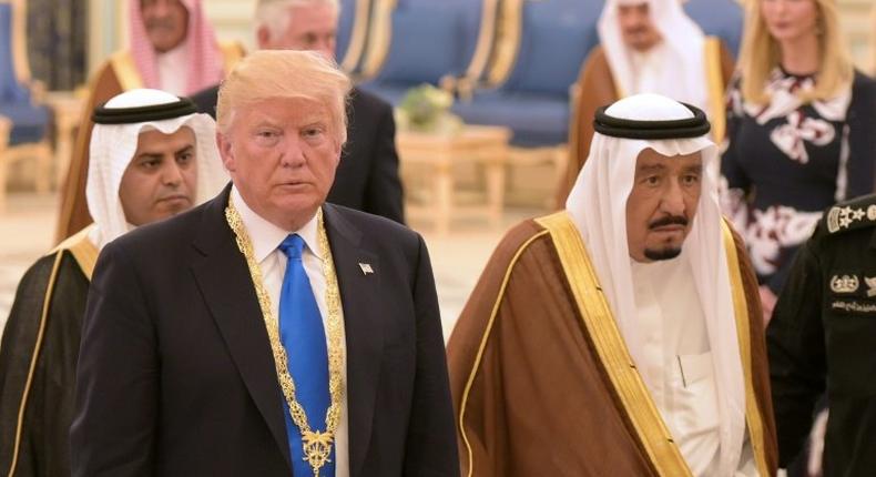 US President Donald Trump (L) walks with Saudi Arabia's King Salman bin Abdulaziz al-Saud after receiving the Order of Abdulaziz al-Saud medal from at the Saudi Royal Court in Riyadh on May 20, 2017.