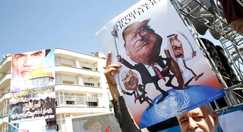 An Iranian man holds a poster bearing images of Israeli Prime Minister Benjamin Netanyahu, US President Donald Trump and Saudi King Salman during a parade. Trump had described a 2015 nuclear accord with Iran as the worst deal ever and accused Iran of continuing to back terrorism in the Middle East.