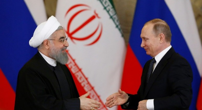 Russian President Vladimir Putin (R) shakes hands with his Iranian counterpart Hassan Rouhani during a joint press conference following their meeting at the Kremlin in Moscow on March 28, 2017