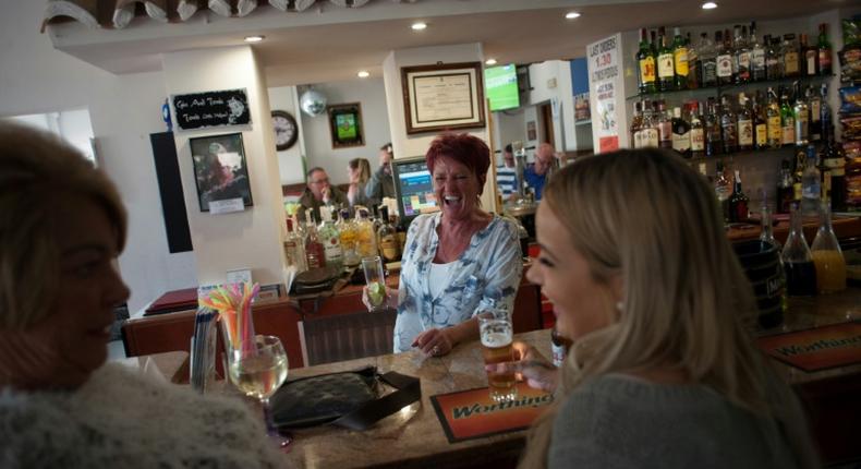 People drink in a bar in Benalmadena, southern Spain, in March 2017 -- Spain is the number one destination for British nationals living outside Britain, ahead of France and Ireland