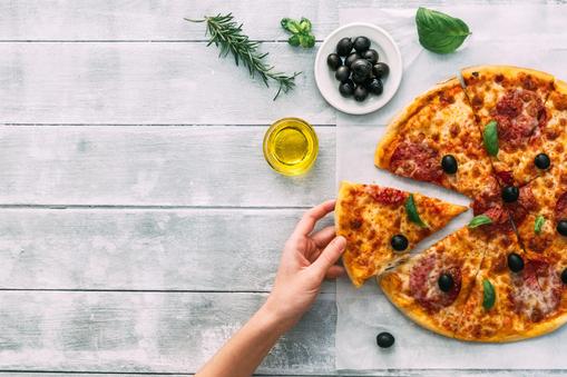 colorful tasty pizza. woman taking piece of italian pizza