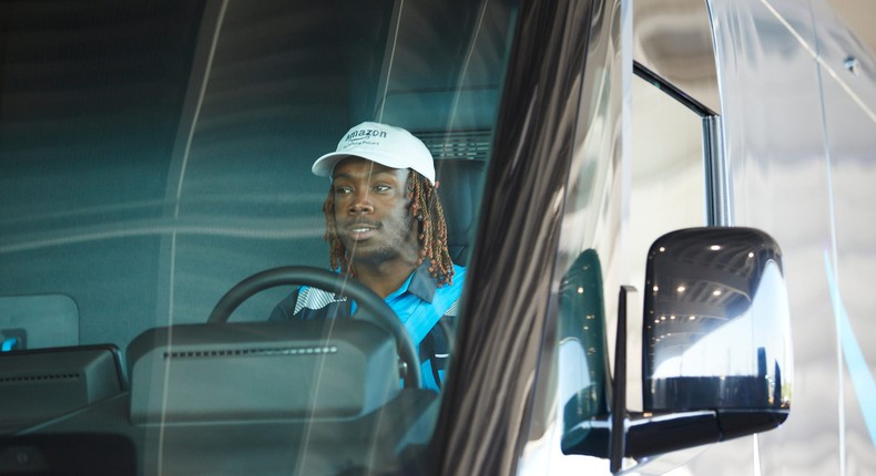 An Amazon driver uses a custom Rivian electric delivery vehicle.Mustafa Hussain/Getty