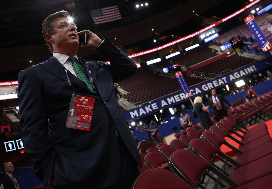 Paul Manafort, Campaign Manager for Donald Trump, speaks on the phone while touring the floor of the Republican National Convention at the Quicken Loans Arena as final preparations continue July 17, 2016 in Cleveland, Ohio.