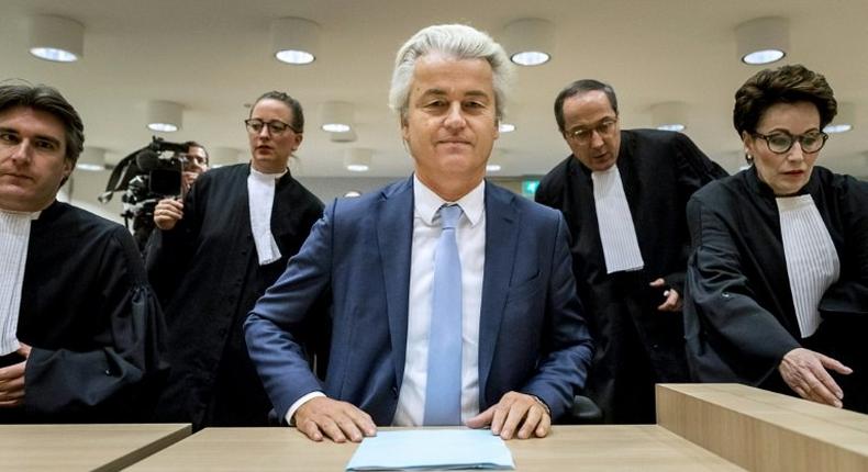 Geert Wilders (C) of the Party for Freedom (PVV) awaits a verdict on charges of insulting a racial group and inciting racial hatred