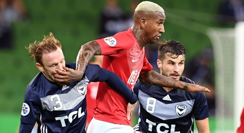 Guangzhou's Anderson Talisca fends off Melbourne Victory's Corey Brown (left) and Terry Antonis