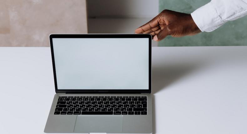 A person using Macbook Pro on white table [Photo: Cottonbro Studio]