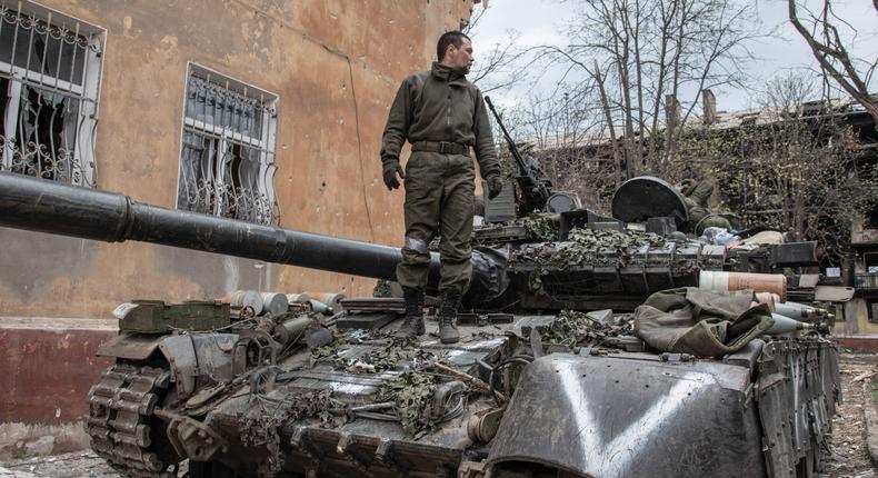 A Russian soldier stands atop hit T-80 MBT in a position close to Mariupol's embattled Azovstal plant as his unit prepares for an assault on 18 April 2022.
