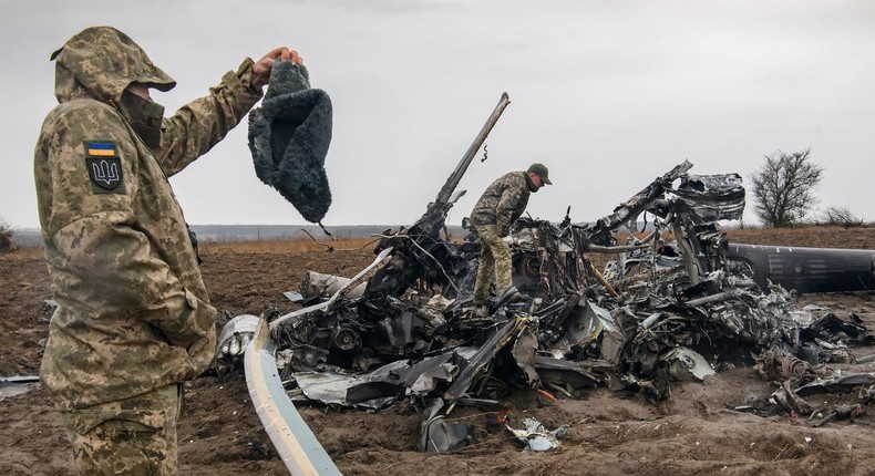 Ukrainian troops inspect a wrecked Russian Mi-8 helicopter near Makariv, April 9, 2022.