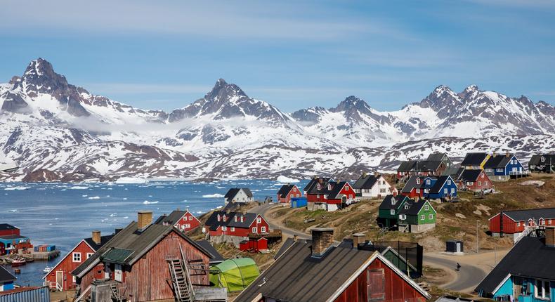 FILE PHOTO: Snow covered mountains rise above the harbour and town of Tasiilaq, Greenland, June 15, 2018. REUTERS/Lucas Jackson/File Photo