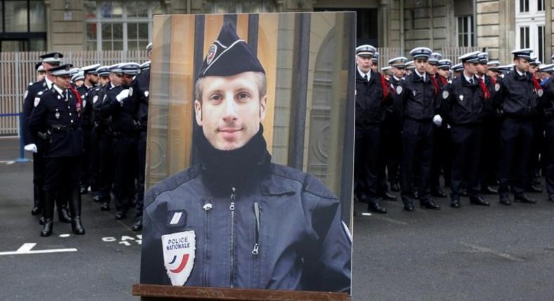 A portrait of Xavier Jugele, the policeman killed by a jihadist on the Champs Elysee, was honoured at a ceremony led by President Francois Hollande