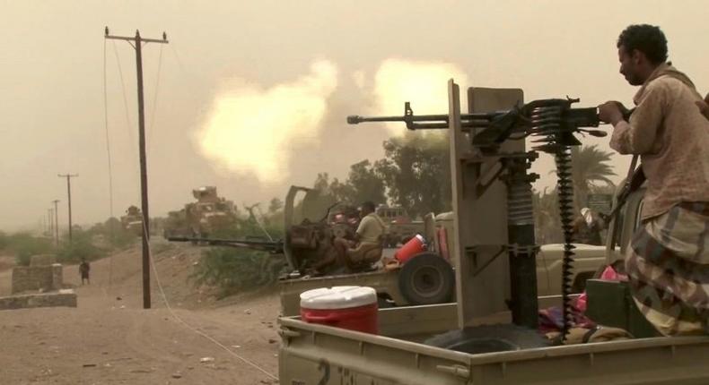 This image grab taken from a AFPTV video shows Yemeni pro-government forces firing a heavy machine gun at the south of Hodeida airport, in Yemen's Hodeida province on June 15, 2018