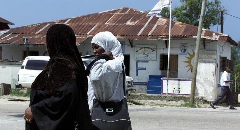 Two muslim women walk past offices of the Civic United Front on Tanzania's Pemba in a file photo.