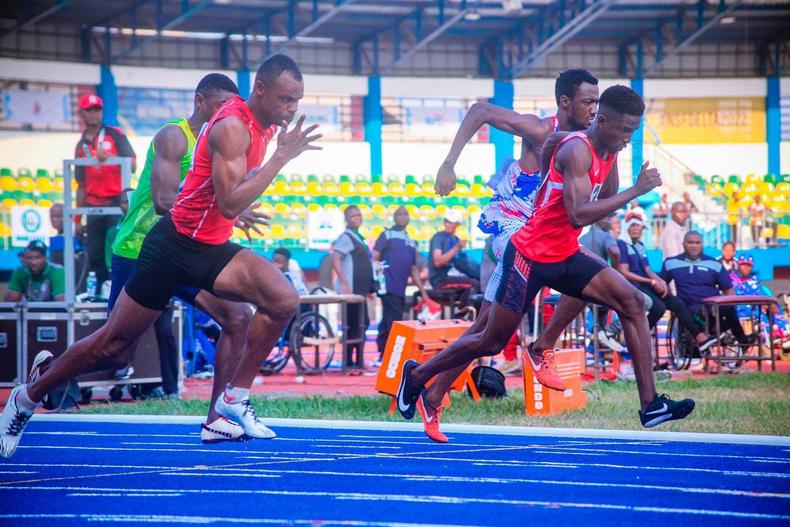 Athletes in action during the 100M heat