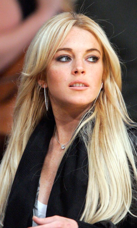 ** FILE ** Actress Lindsay Lohan is seen at the Los Angeles Lakers game against the Orlando Magic, in this Dec. 2, 2007, file photo in Los Angeles. Sales of Britney Spears-related eBay items topped those for Paris Hilton and Lindsay Lohan in 2007, according to the popular online auction site. There were 34,345 Spears-related items sold this year  while 27,377 items associated with Hilton were purchased. Lohan's name was only associated with 8,099 items sold. (AP Photo/Mark J. Terrill, file)