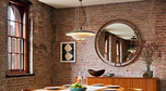 Naturalna cegła i drewniane stropy nadają mieszkaniu loftowego charakteru
