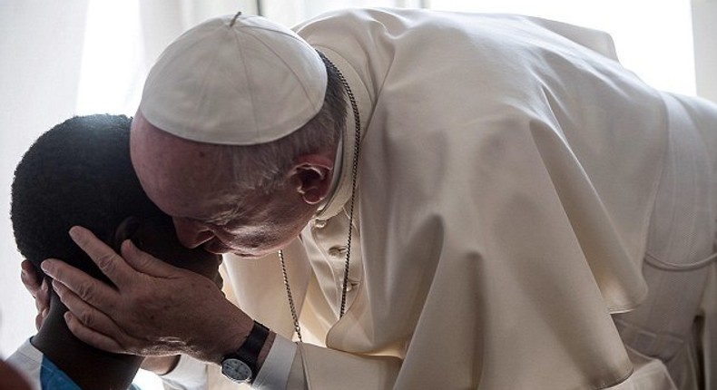 Pope Francis surprised 20 former prostitutes on Friday by knocking on their door in Rome and popping in for a chat. He is pictured here greeting one of the women